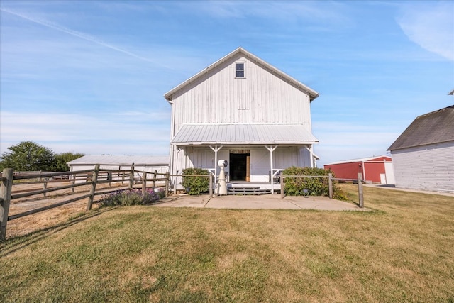 rear view of property with a lawn and a patio area