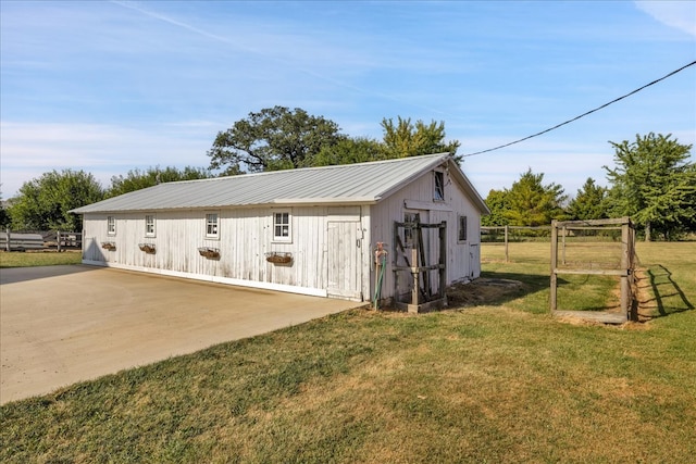 garage featuring a yard and wooden walls