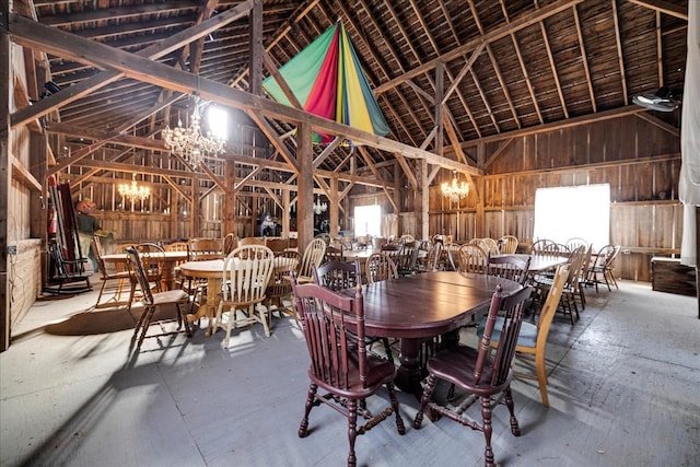 dining area with high vaulted ceiling