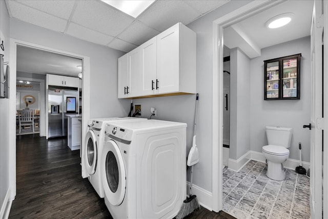 laundry room featuring dark hardwood / wood-style flooring and washer and dryer