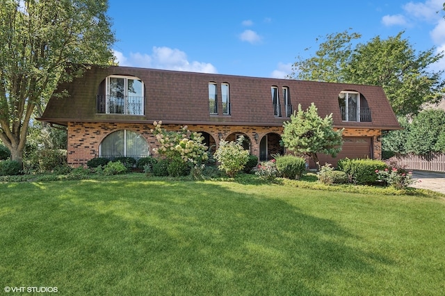 view of front of home with a garage and a front lawn