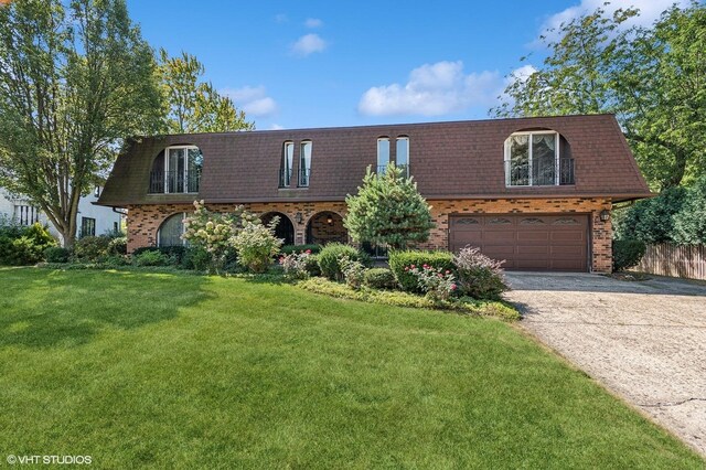 view of front of property featuring a garage and a front lawn