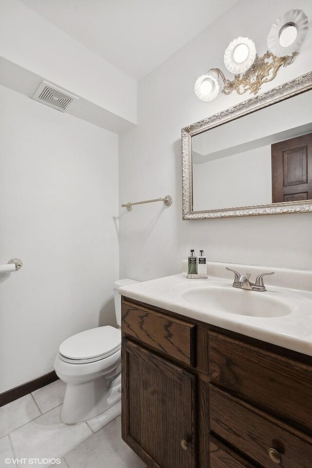 bathroom featuring vanity, toilet, and tile patterned floors