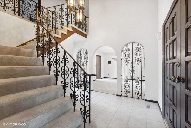 foyer featuring a notable chandelier and a high ceiling