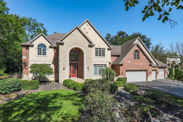 view of front facade with a garage and a front lawn