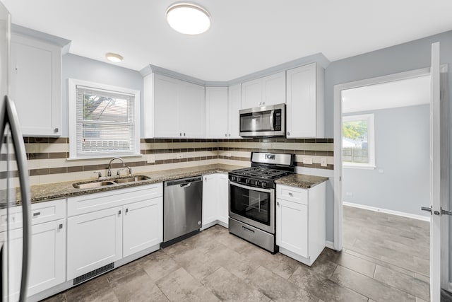 kitchen with white cabinetry, stainless steel appliances, and plenty of natural light