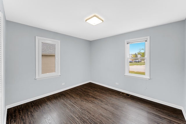 empty room featuring dark hardwood / wood-style flooring