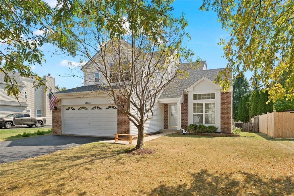 view of front of house featuring a front lawn and a garage