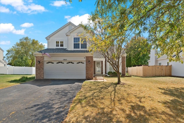 view of front facade with a garage and a front lawn