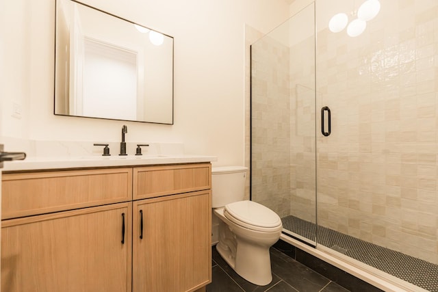 bathroom featuring vanity, a shower with shower door, tile patterned floors, and toilet