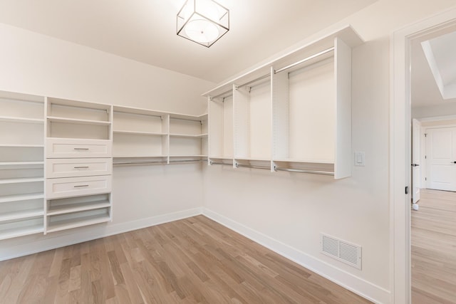 spacious closet with light hardwood / wood-style floors