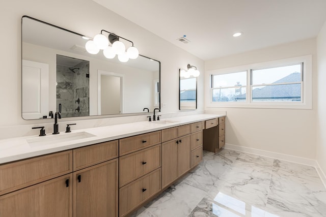 bathroom with vanity and a shower with door