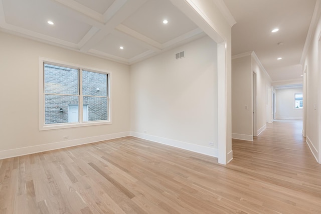 empty room with coffered ceiling, crown molding, light hardwood / wood-style flooring, and beam ceiling