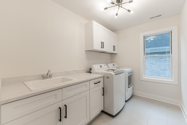 laundry room featuring sink, cabinets, and washing machine and clothes dryer