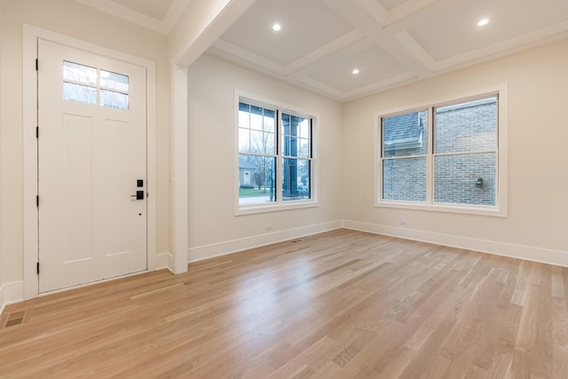 foyer entrance with coffered ceiling, beam ceiling, and light wood-type flooring