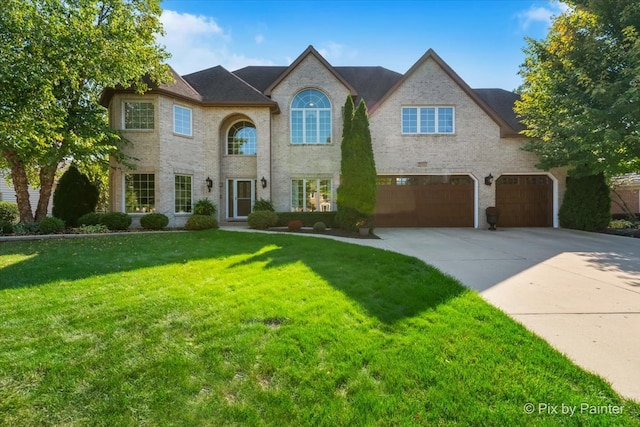 view of front of house with a front yard and a garage