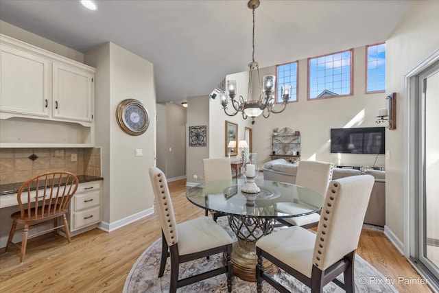 dining area featuring a chandelier and light hardwood / wood-style flooring