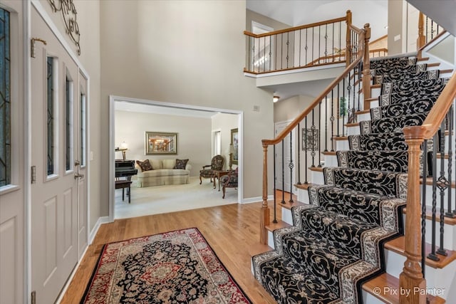 entryway with a high ceiling and hardwood / wood-style flooring