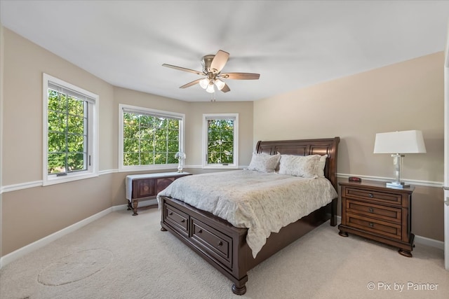 bedroom featuring ceiling fan and light colored carpet