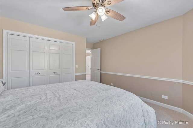 carpeted bedroom with a closet and ceiling fan