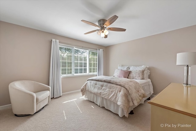 bedroom featuring ceiling fan and light carpet