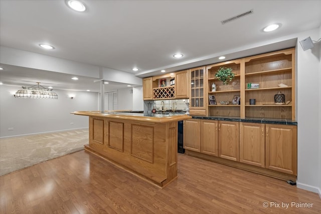 bar featuring light hardwood / wood-style floors