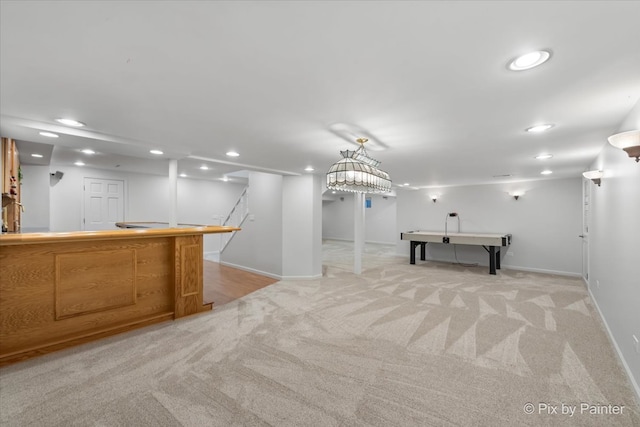 interior space with light colored carpet and hanging light fixtures