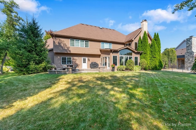 back of property featuring a lawn and a patio area