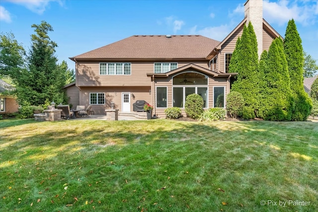 rear view of property with a patio area and a yard