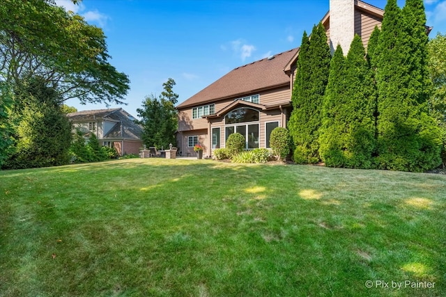 rear view of house with a lawn