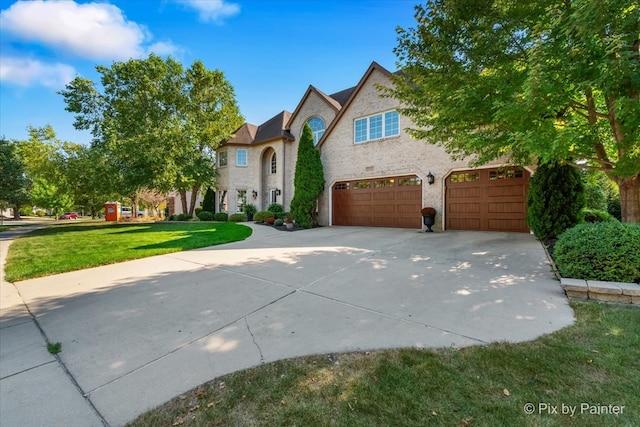 view of front facade with a front yard and a garage