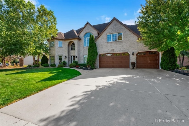 french provincial home featuring a garage and a front lawn