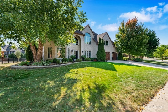 view of front of house featuring a garage and a front lawn