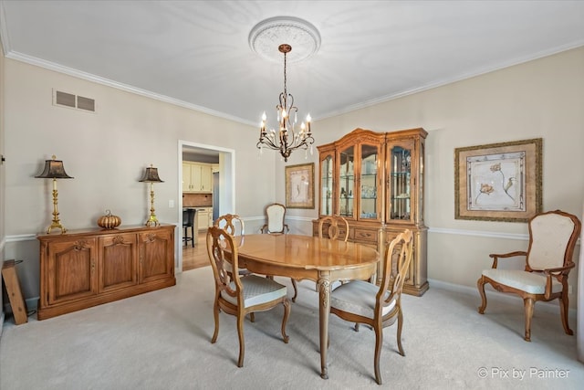 dining area with light carpet, an inviting chandelier, and ornamental molding