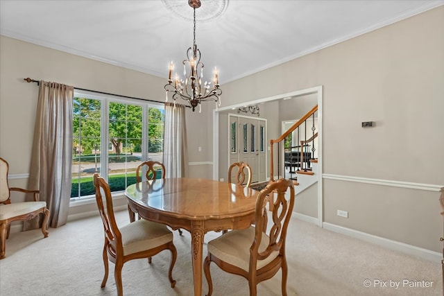 carpeted dining room with a notable chandelier and ornamental molding