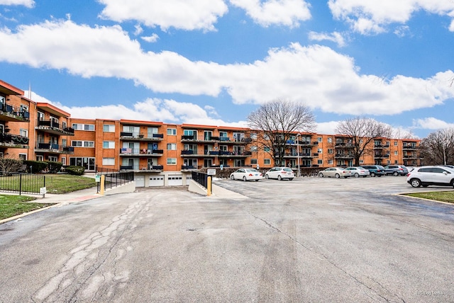 view of building exterior with uncovered parking