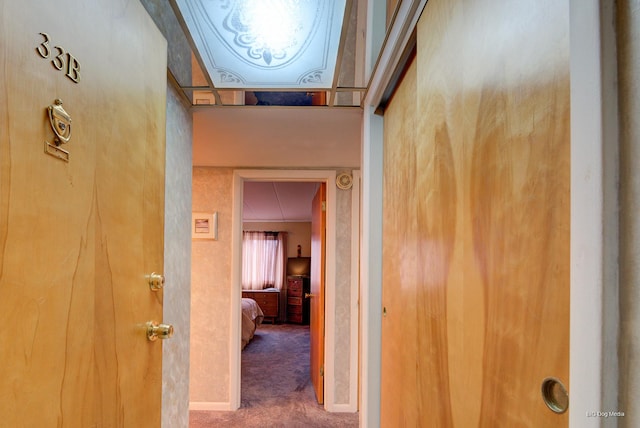 hall with carpet and baseboards