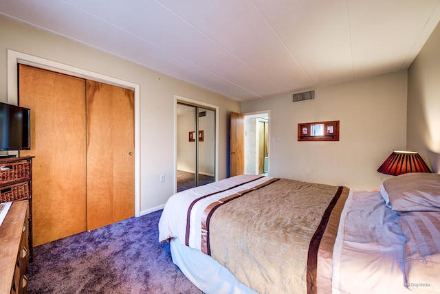 carpeted bedroom featuring visible vents and multiple closets