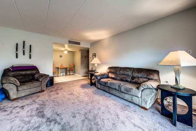 living room featuring ceiling fan, visible vents, and carpet