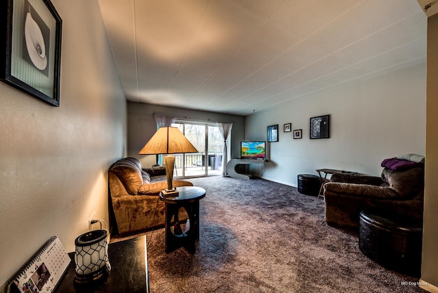 carpeted living area with baseboards