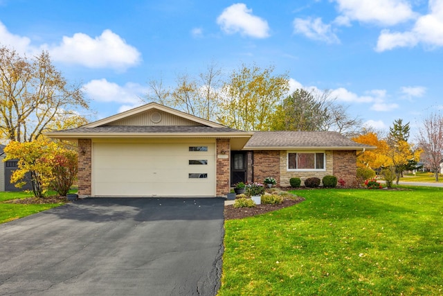 ranch-style home with a front lawn and a garage