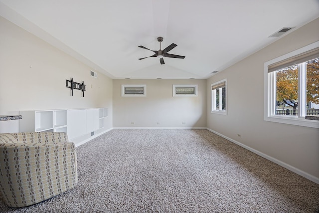 unfurnished living room featuring ceiling fan and carpet flooring