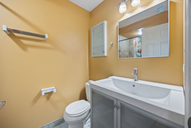 bathroom featuring curtained shower, toilet, vanity, and tile patterned flooring