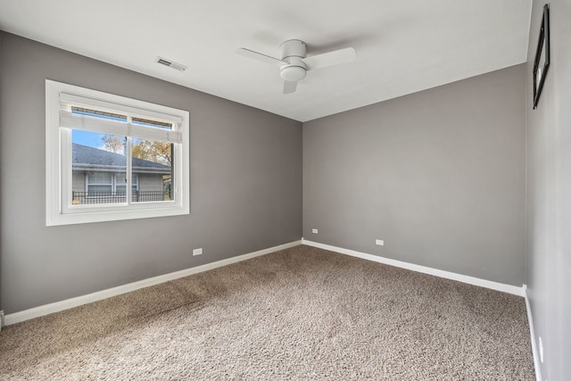 spare room featuring ceiling fan and carpet flooring