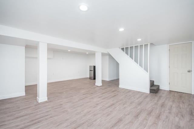 basement with light hardwood / wood-style floors