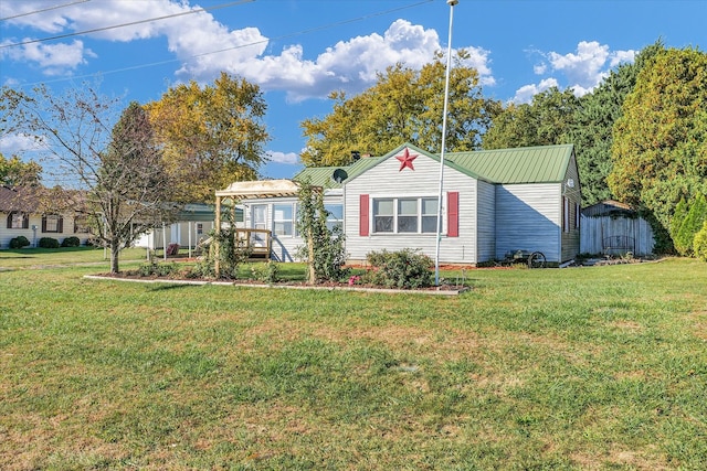 single story home featuring a front yard and a storage unit