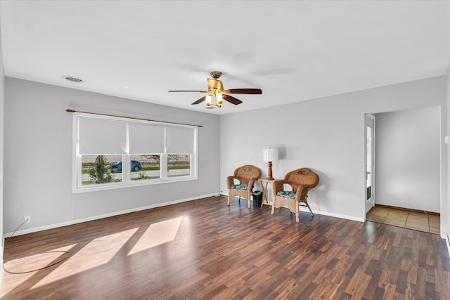 living area with ceiling fan and dark hardwood / wood-style flooring