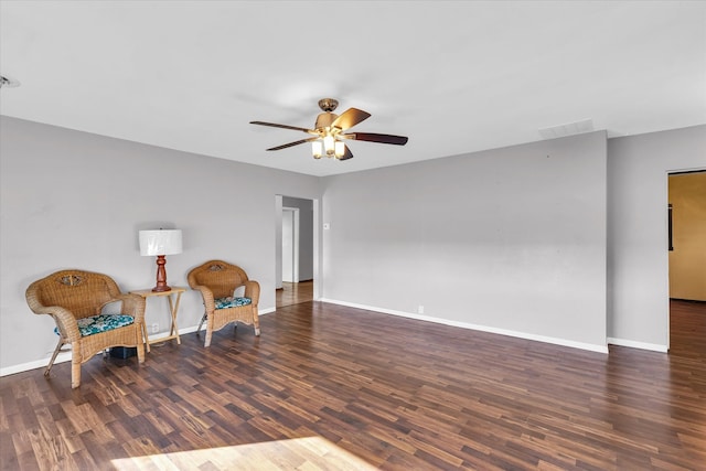 living area with ceiling fan and dark hardwood / wood-style floors