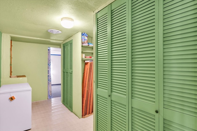 hall with a textured ceiling