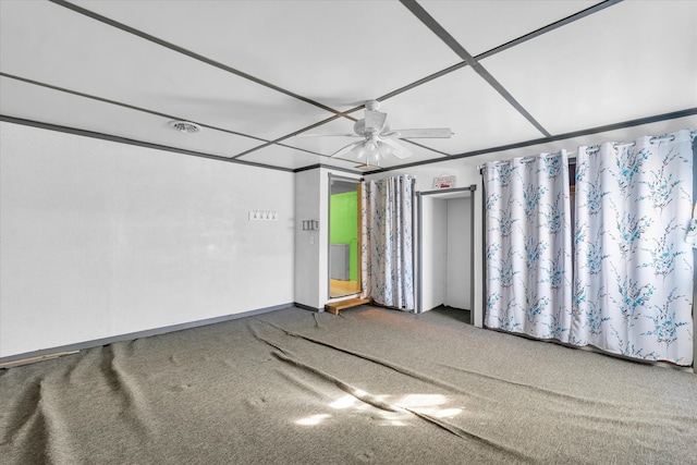 carpeted spare room featuring ceiling fan